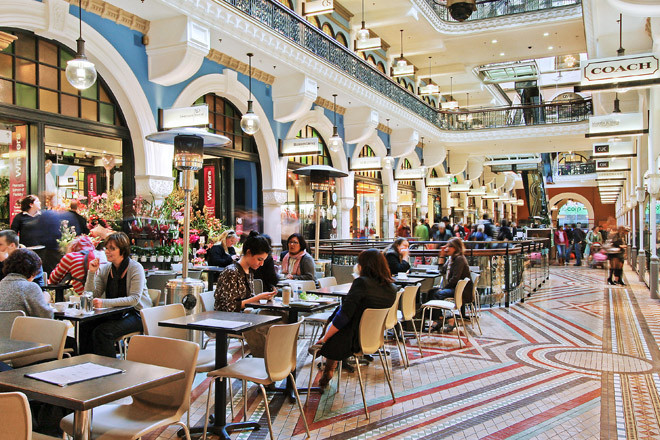 Interior arcade of the Queen Victoria Building with cafe seating