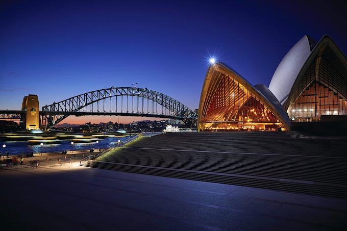 Sydney Harbour Bridge and Opera House lit up at night