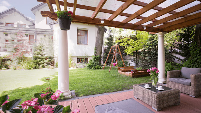 Timber pergola with a clear polycarbonate roof over a garden patio seating area