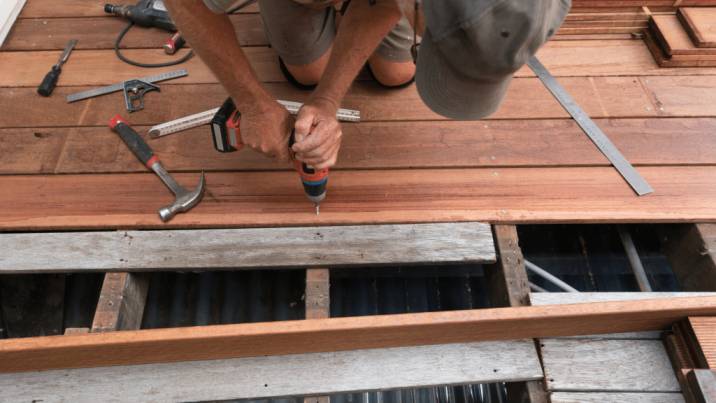 Tradesperson installing timber decking boards