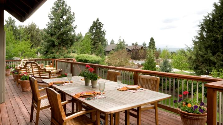Covered timber deck with an outdoor dining table
